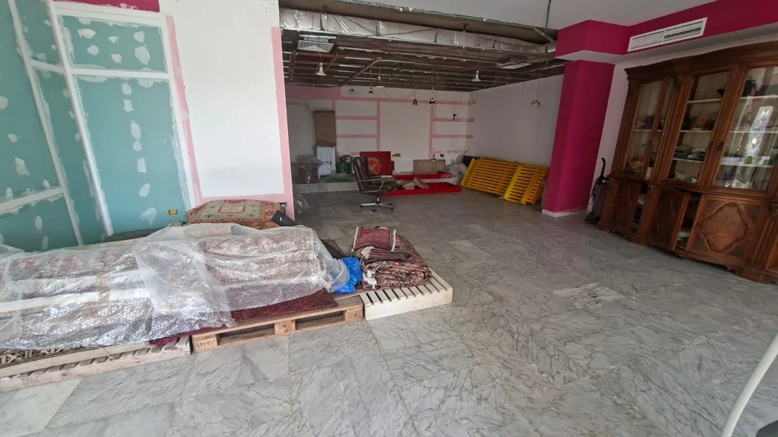 Open 150 square metre shop floor in Sahel Alma with marble flooring and fitted display cabinets