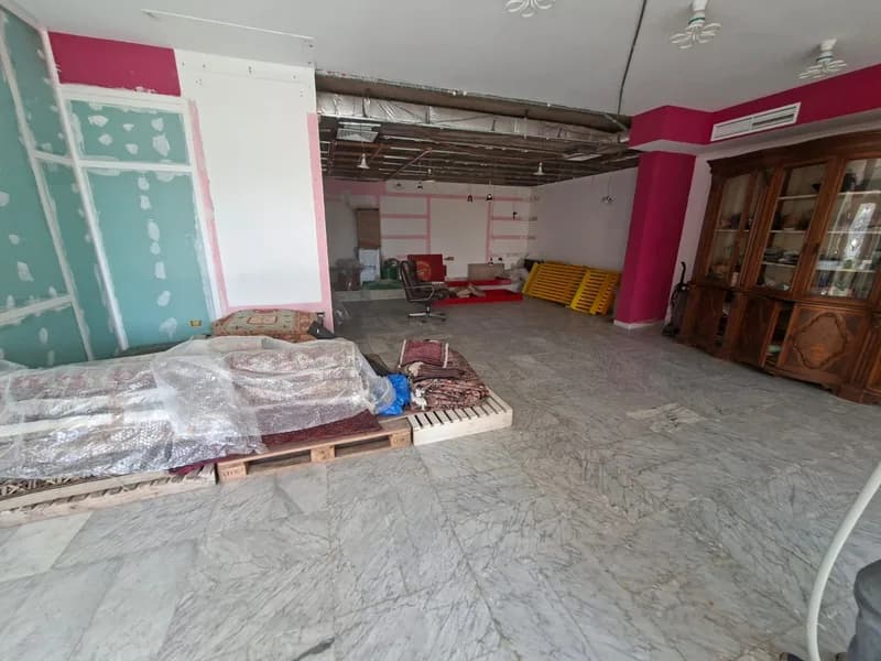 Open 150 square metre shop floor in Sahel Alma with marble flooring and fitted display cabinets