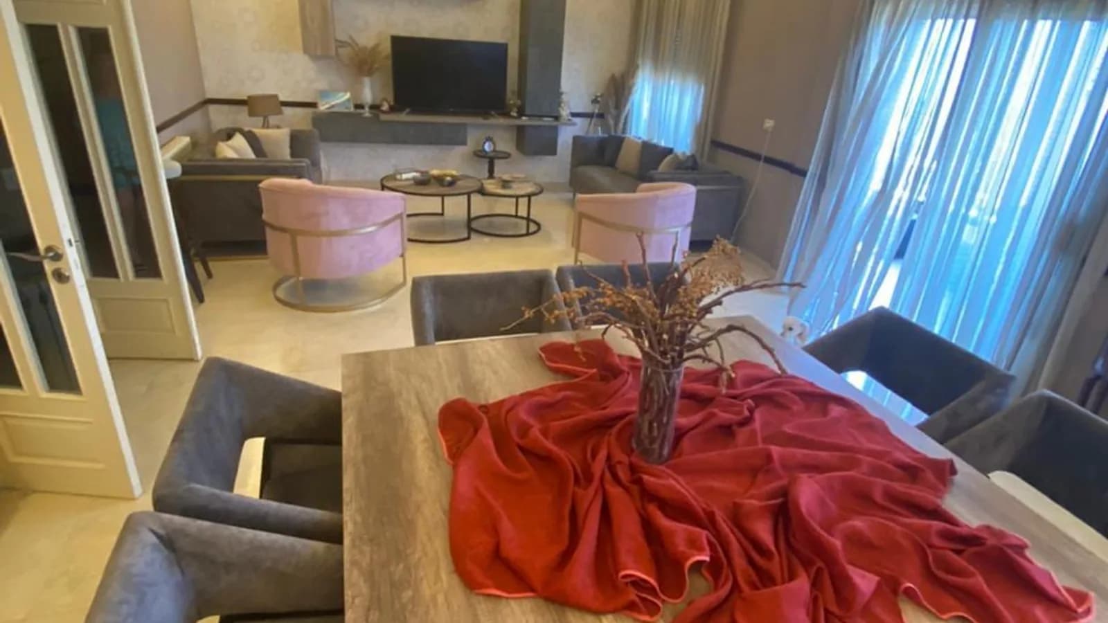 Renovated salon and dining area of the Ballouneh apartment, with cove lighting and a large dining table