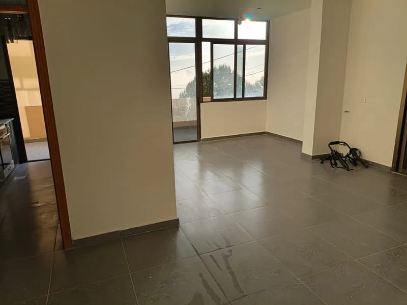 Main salon of the Ghedras apartment with windows across two walls